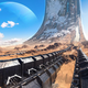A snow covered Halo ring ascends up from a desert landscape on a bluebird day with a planet in the background in Halo Infinite's multiplayer technical test.